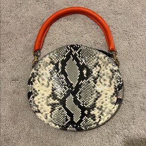 Clare V. Python printed circle clutch with orange handle